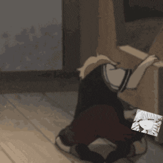 a boy is kneeling down with a picture of a girl on the floor behind him .