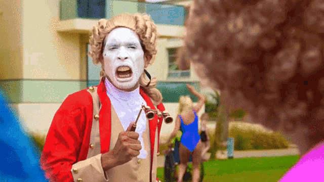 a man with white paint on his face is holding a pair of binoculars in his hand