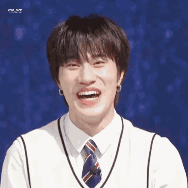 a young man wearing a white shirt and tie is smiling for a photo taken by for_bvd