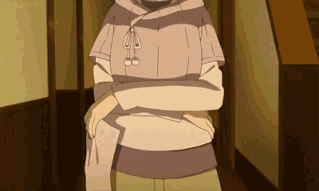 a person with their arms crossed is wearing a striped sweater