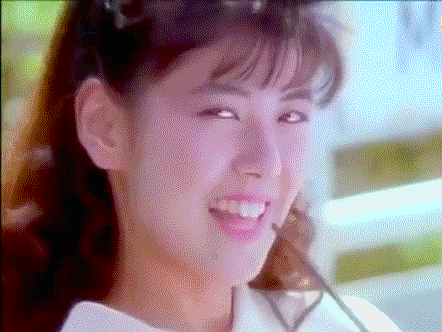 a close up of a woman 's face smiling