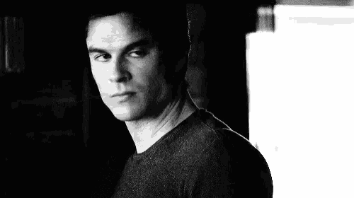 a black and white photo of a man with his eyes closed and a serious look on his face .