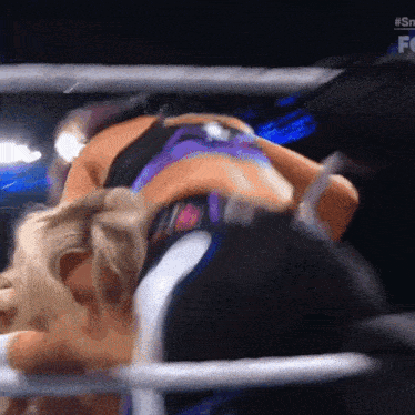 two women wrestling in a ring with the hashtag #sn