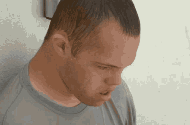 a man with down syndrome looks down at something