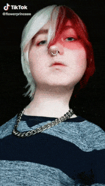 a girl with red and white hair and a nose ring .
