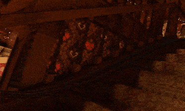 a red train with snowflakes on the side is going down a set of stairs