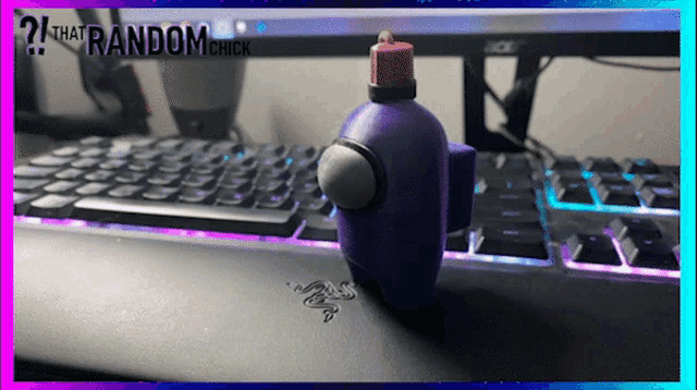 a purple among us figurine sits on a keyboard with the words that random chick in the corner