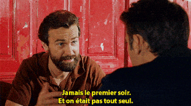 a man with a beard is talking to another man with the words " jamais le premier soir " on the bottom