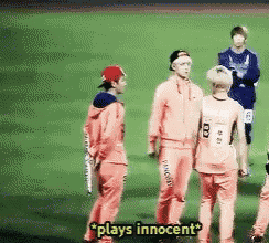 a group of people standing on a field with the words plays innocent