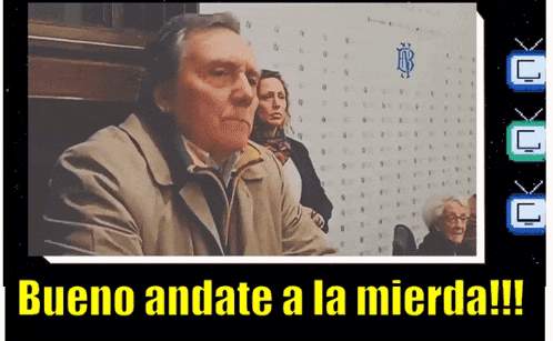 a man sitting in front of a wall with a sign that says bueno andate a la mierda !!!