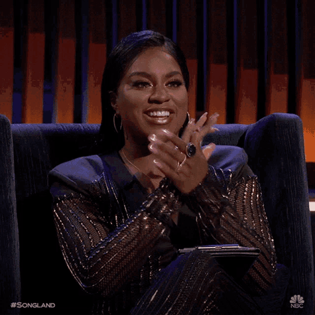 a woman sits in a chair with her hands together and the words songland on the bottom right