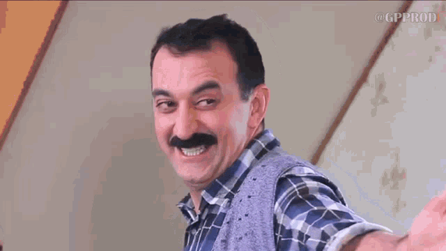a man with a mustache is smiling and the words axpeeers are written below him