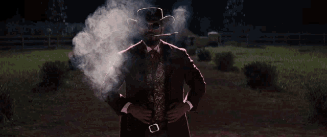 a man in a cowboy hat smoking a cigar
