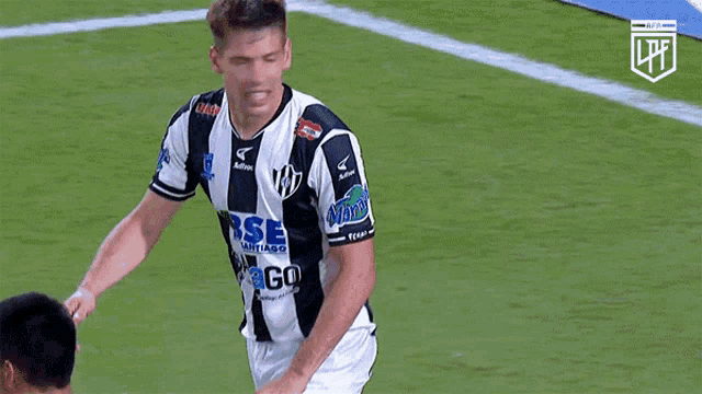 a soccer player wearing a black and white jersey that says lpfl on it