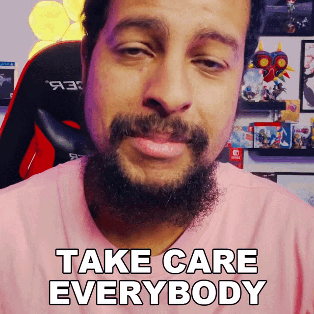 a man with a beard and a pink shirt says take care everybody