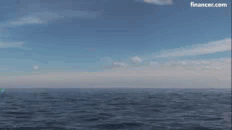 an explosion in the ocean with a coin in the foreground .