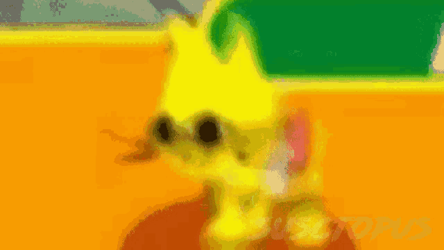 a blurred image of a yellow cartoon character with the word sustopus on the bottom right