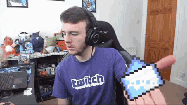 a man wearing headphones and a purple shirt with the word twitch on it