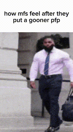 a man in a white shirt and blue tie is walking down a street