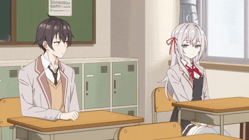 a boy and a girl sit at desks in a classroom with a sign on the wall that says ' a ' on it