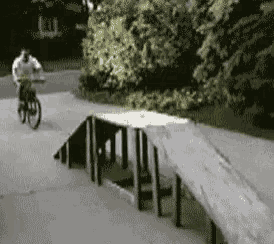 a pixelated image of a person riding a bike on a sidewalk