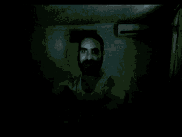 a man with a beard is pointing at the camera
