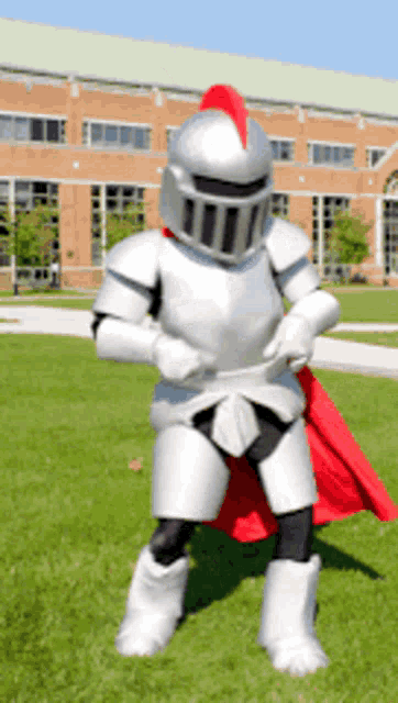 a person dressed as a knight with a red cape on