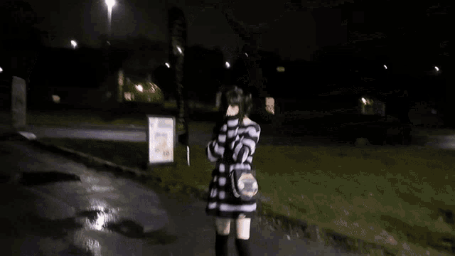 a blurry picture of a girl wearing a striped sweater