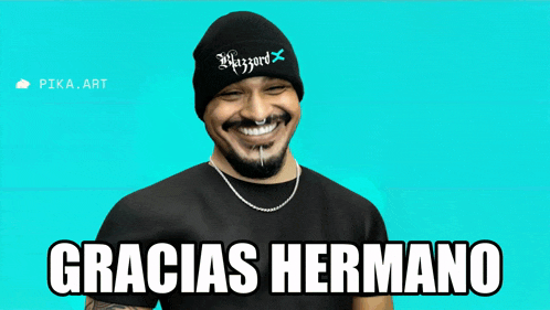 a man wearing a black beanie and a black shirt with gracias hermano written on it