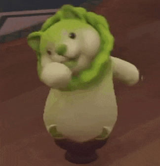 a stuffed animal is wearing a green cabbage hat and dancing .
