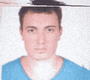 a man in a blue shirt looks at the camera