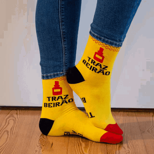 a pair of yellow socks that say traz beirão on them