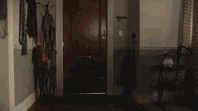 a hallway with a wooden door and a letterbox