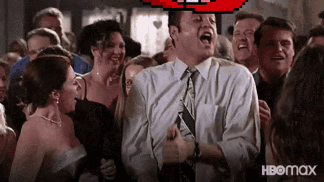 a man in a suit and tie is dancing in front of a crowd with hbomax written on the bottom right