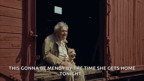 an elderly man sits on a train car with a dog and says this gonna be mendy by the time she gets home
