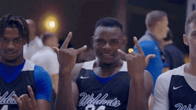 a group of basketball players are posing for a picture and one of them is wearing a number 24 jersey .