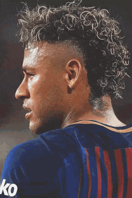 a close up of a soccer player 's face wearing a yellow shirt