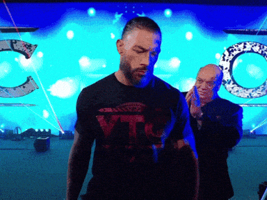 a man wearing a t-shirt that says ytj walks on stage
