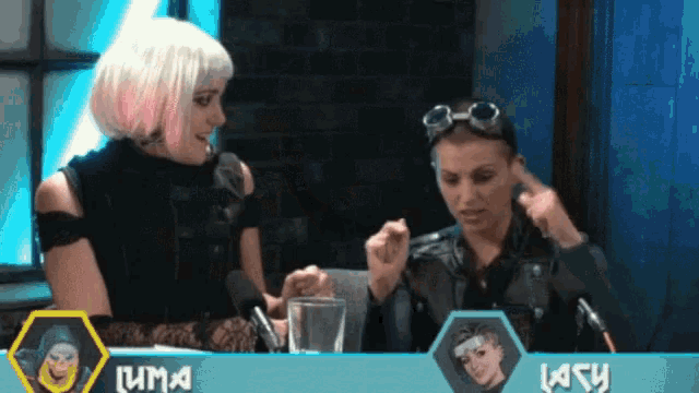 two women are sitting in front of microphones and a sign that says luma