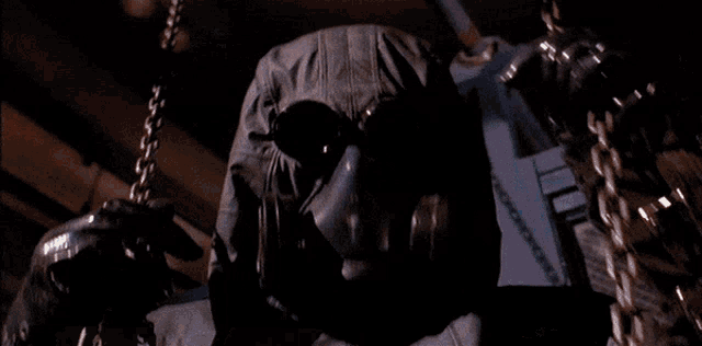 a man in a gas mask stands behind two men