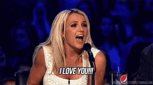 britney spears is sitting in front of a microphone saying i love you