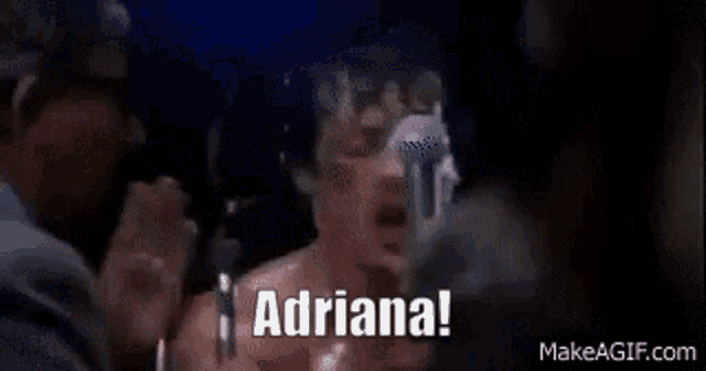 a man in a boxing ring is screaming into a microphone and saying adriana