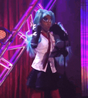 a woman in a costume is standing on a stage holding a microphone .
