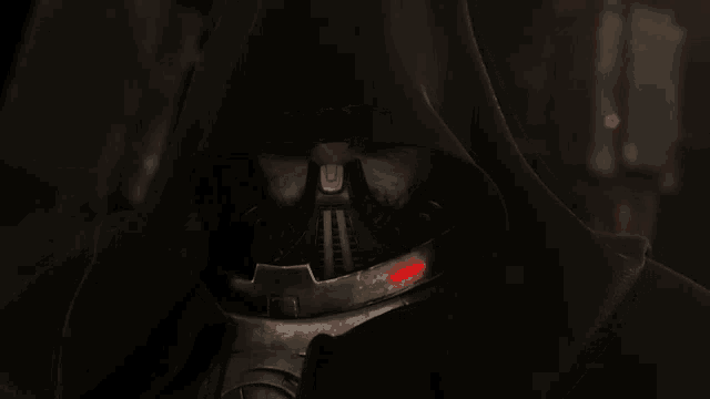 a close up of a hooded figure with a mask on his face