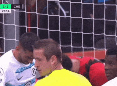 a soccer game is being played with the score 1-1