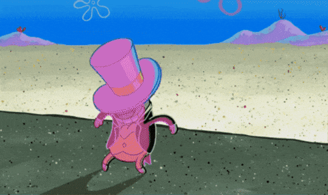 a pink cartoon character wearing a top hat stands on a sandy beach