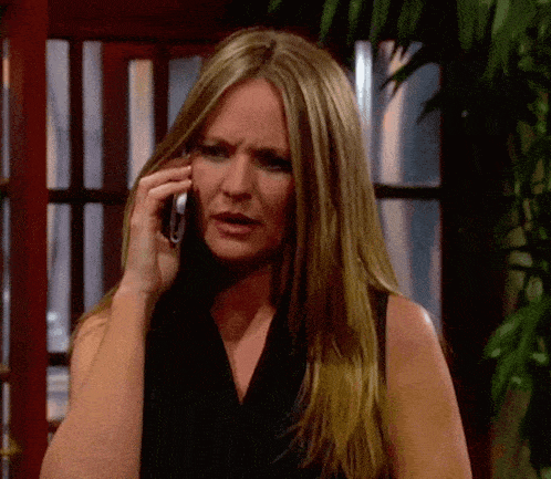 a woman is talking on a cell phone and making a funny face