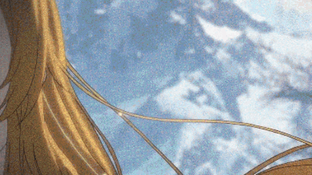a close up of a person 's hair in front of a mountain .