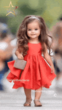 a little girl in a red dress is walking down the runway
