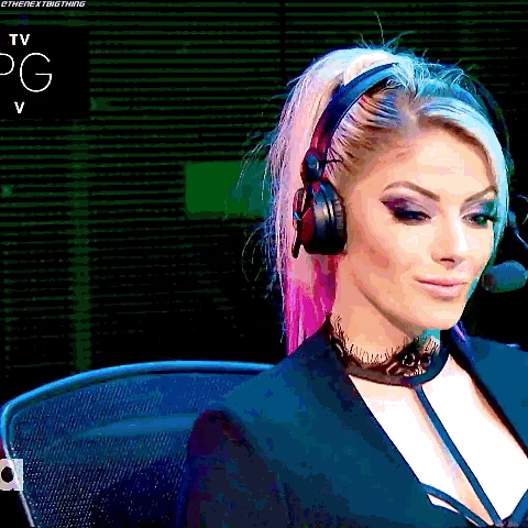 a woman wearing headphones and a choker is sitting in a chair .